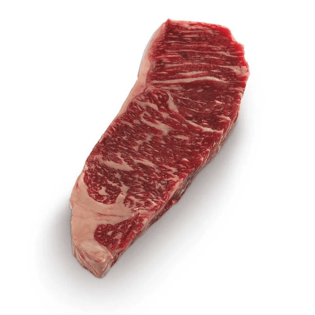 A raw, marbled cut of steak sits on a white background. The meat has a rich, red color with white marbling, showcasing its fat distribution.