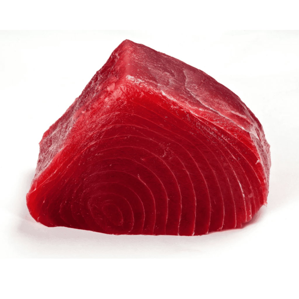 A close-up image of a thick, triangular slice of raw tuna. The tuna slice is bright red with a smooth surface and visible muscle fibers. The background is plain white, highlighting the vibrant color and texture of the fish.